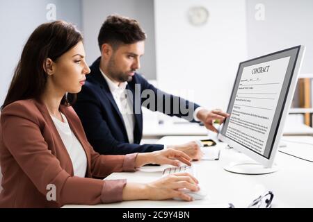 Reading Legal Law Contract On Desktop Computer Screen Stock Photo