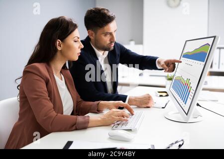 Financial Advisor And Business Analyst Working On Computer Stock Photo