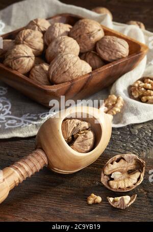 Nutcracker and walnuts  on wooden background Stock Photo