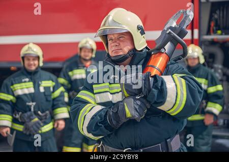 Strong man is holding equipment in hands Stock Photo
