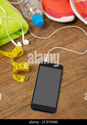Mobile phone with blank screen and sport equipment Stock Photo