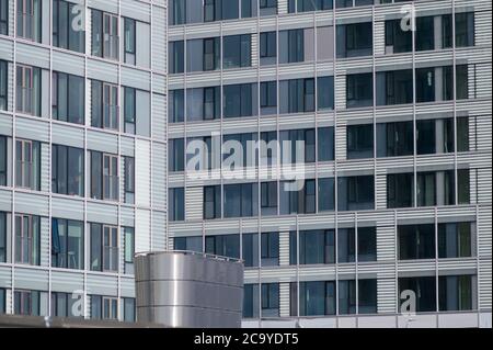 Helsinki / Finland - July 30, 2020: Two urban buildings with large glass windows and white walls. Stock Photo