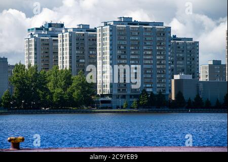 Helsinki / Finland - July 30, 2020: Urban metropolitan borough with tall concrete residential buildings on a sunny summer day. Stock Photo