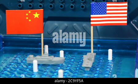 American, U.S, USA United States of American Naval Navy warship meet Chinese navy ship on a Battleship Board game. National flags. Disputed South Chin Stock Photo