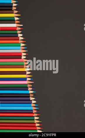 Multi-colored pencils on blackboard Stock Photo