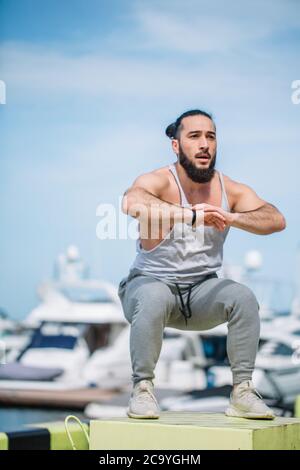 Sportsman fit male jumper doing explosive strength training jumps, crossfit fitness workout strenght power concept . Handsome strong man exercising on Stock Photo