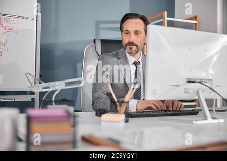 Male worker using modern computer in office Stock Photo