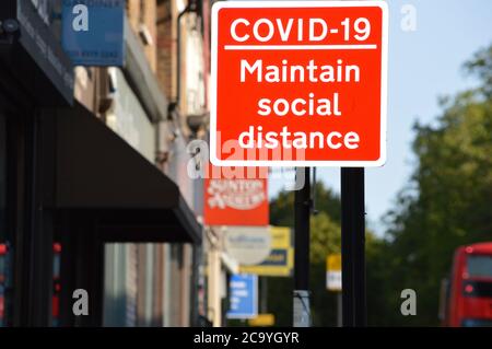 London, UK. 3 August 2020. A COVID-19 maintain social distance notice lamp posted, warning the general public that this measure should be followed. Stock Photo