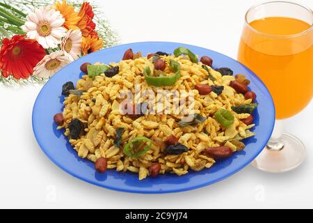 Jada Poha Namkeen Chivda / Thick Pohe Chiwda is a jar snack with a mix of sweet, salty and nuts flavours, served with Cold drinks. selective focus - I Stock Photo