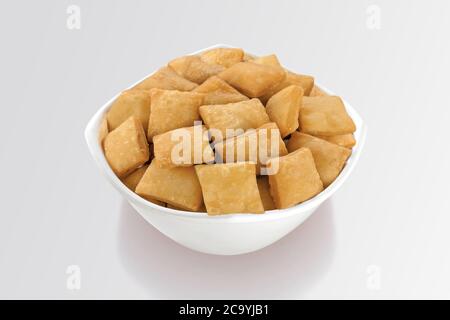 Shakkar pare Also Know as Shakkarpare, Shakarpare, Shakarpali, Shakkar Para, Sakarpara or Shankarpalli or shankar pale is a Snack Typically Stock Photo