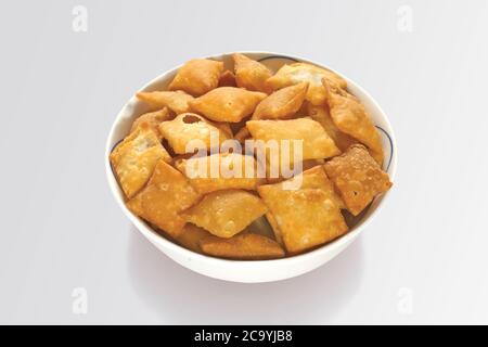 Shakkar pare Also Know as Shakkarpare, Shakarpare, Shakarpali, Shakkar Para, Sakarpara or Shankarpalli or shankar pale is a Snack Typically Stock Photo