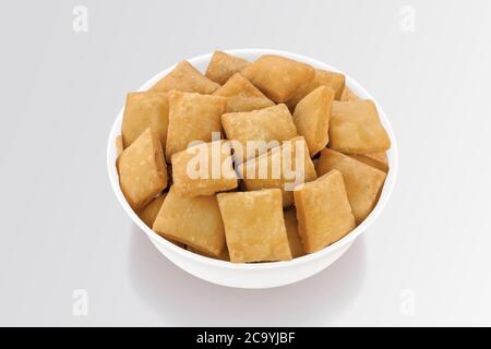 Shakkar pare Also Know as Shakkarpare, Shakarpare, Shakarpali, Shakkar Para, Sakarpara or Shankarpalli or shankar pale is a Snack Typically Stock Photo