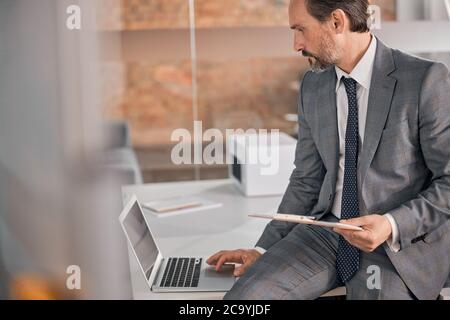 Handsome bearded man using notebook at work Stock Photo