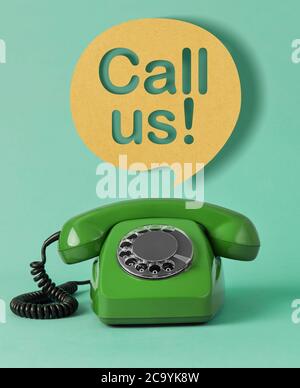 Old telephone with speech bubble on colored background Stock Photo