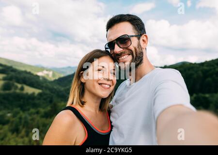 Young couple taking a selfie in the mountains Stock Photo