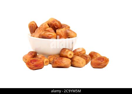 Bowl of pitted Sweet dried dates fruit isolated on white background. - Image Stock Photo