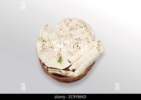 Indian snacks, deep fried or roasted Mung/Urad dal crackers or papad which is a side dish in lunch and dinner. Served in a cane basket /plate Stock Photo