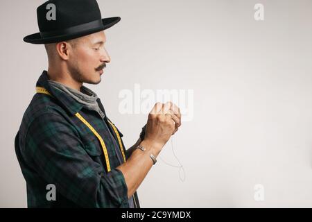 Leather handbag craftsman at work in a workshop, isolated studio photo Stock Photo