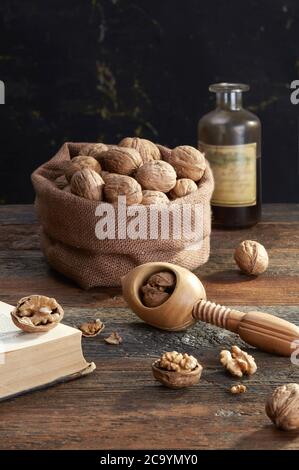 Walnuts and nutcracker  on wooden background Stock Photo