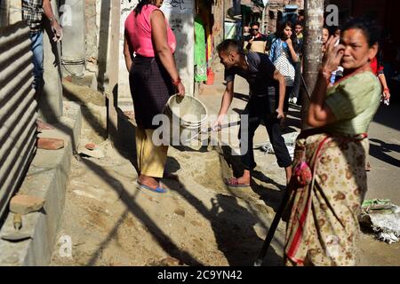 Citizens of Bhaktapur doing construction work in a residential area, one year after the 2015 devastating earthquakes in Nepal. Stock Photo