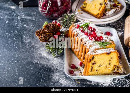 Traditional christmas baking, Festive Xmas fruitcake with dryed fruits, liquer, and cranberry decor. Homemade fruitcake on Chritmas decorated backgrou Stock Photo
