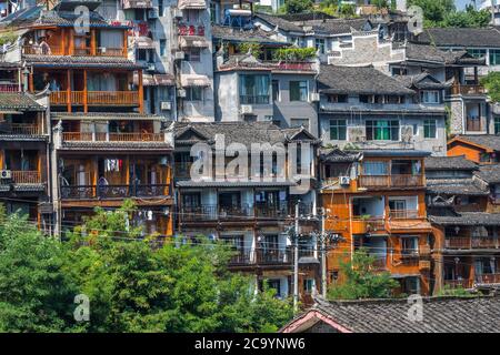 Feng Huang, China -  August 2019 : Facades of row of old historic wooden Diaojiao houses on the riverbanks of Tuo river Stock Photo