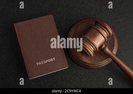 Passports and judge gavel on gray black background. Legal immigration. Obtain citizenship.