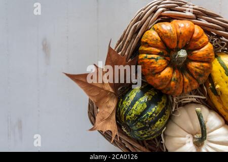 Top view of Basket with pumpkins on rustic table Stock Photo