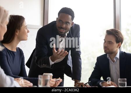 African mentor gives valuable advice to staff members during meeting Stock Photo