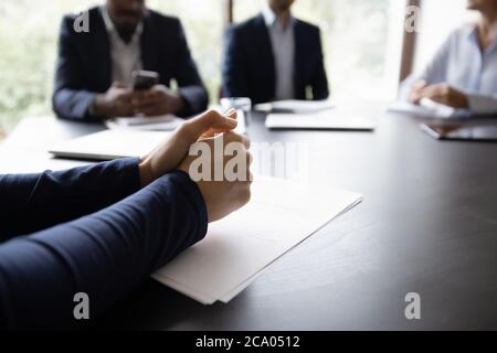 Businessman participates in meeting, put his hands on table closeup Stock Photo