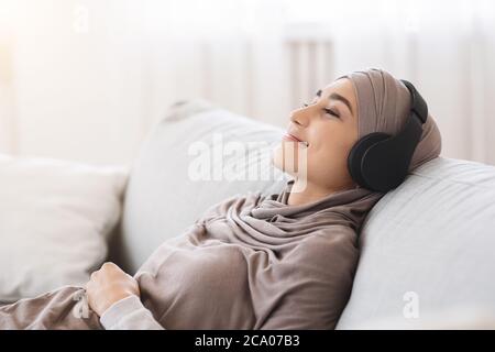 Happy Arabic Woman Listening Music In Wireless Headphones Relaxing At Workplace Stock Photo Alamy Sport arabic music for videos | race music (free download). happy arabic woman listening music in