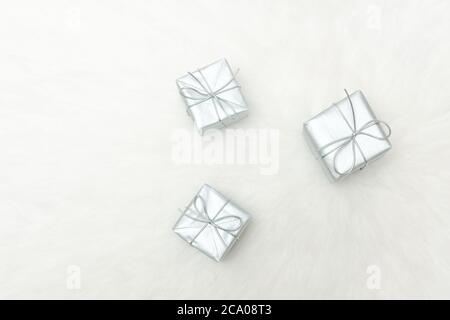 Three silver gift boxes on a white background. Holiday concept Stock Photo