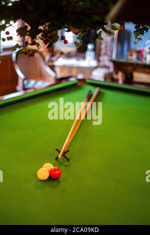 snooker cues and balls on snooker table Stock Photo
