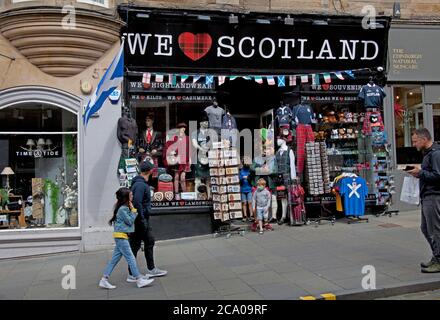 Edinburgh, Scotland, UK. 3 August 2020. Looking a wee bit more normal on the cities streets with some tourists wandering the pavements looking at landmarks and visiting the restaurants on the Royal Mile. Pictured: Cockburn Street just off of the Royal Mile.  Pictured: tourists exit a Scottish souvenir shop. Credit: Arch White/ Alamy Live News. Stock Photo