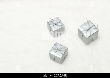 Three silver gift boxes on a white background. Holiday concept Stock Photo