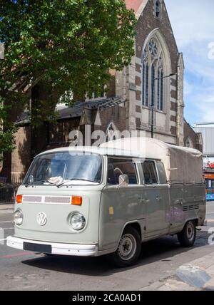 A vintage Volkswagen camper van parked in a suburban street ...
