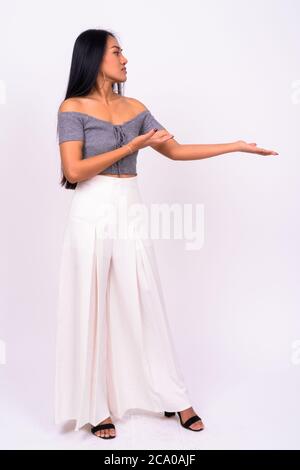 Young beautiful Asian woman against white background Stock Photo