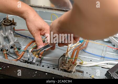 man fixing a gas cooker Stock Photo