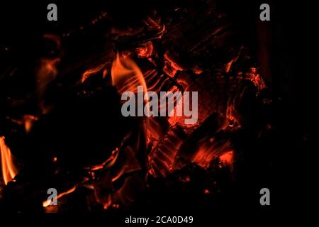 Log on fire burning billets in fireplace.Burning woods open fire background.selective focus.Barbecue Flaming Charcoal Grill With Bright Flames Of Fire Stock Photo