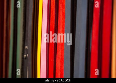 An assortment of multi-coloured leather belts at a market stall in Camden, north London, England, U.K. Stock Photo