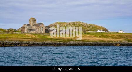 View of historic Iona Abbey, Isle of Mull, Inner Hebrides, Scotland, UK seen from the sea Stock Photo