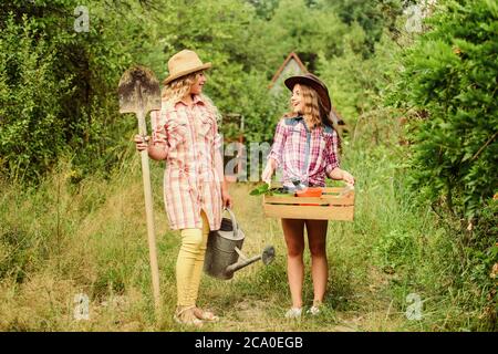 Beautiful female florists. earth day. summer family farm. small girls farmer in village. farming and agriculture. spring country side. children hold g Stock Photo