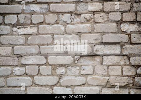 Real old brick wall crumbling from time to time Stock Photo