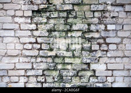 Real old brick wall crumbling from time to time Stock Photo