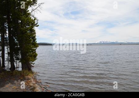 Late Spring in Yellowstone National Park: Flat Mountain with Mount Sheridan of the Red Mountains Seen From Near Picnic Area Along Yellowstone La Stock Photo