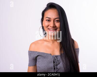 Portrait of happy young beautiful Asian woman with braces Stock Photo