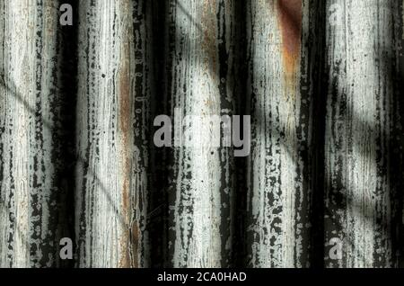 Light and shadow play on corrugated iron farm building Stock Photo
