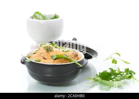 boiled bulgur groats with vegetables and herbs in a ceramic bowl Stock Photo