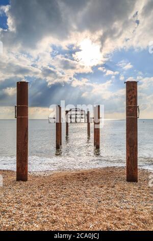 West Pier in Brighton with sunbeams shining through the clouds Stock Photo