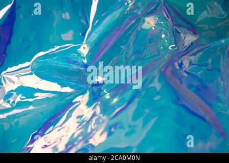 Blue soft focus holographic wallpaper. Wrinkled foil texture. Blurred abstract concept. Stock Photo